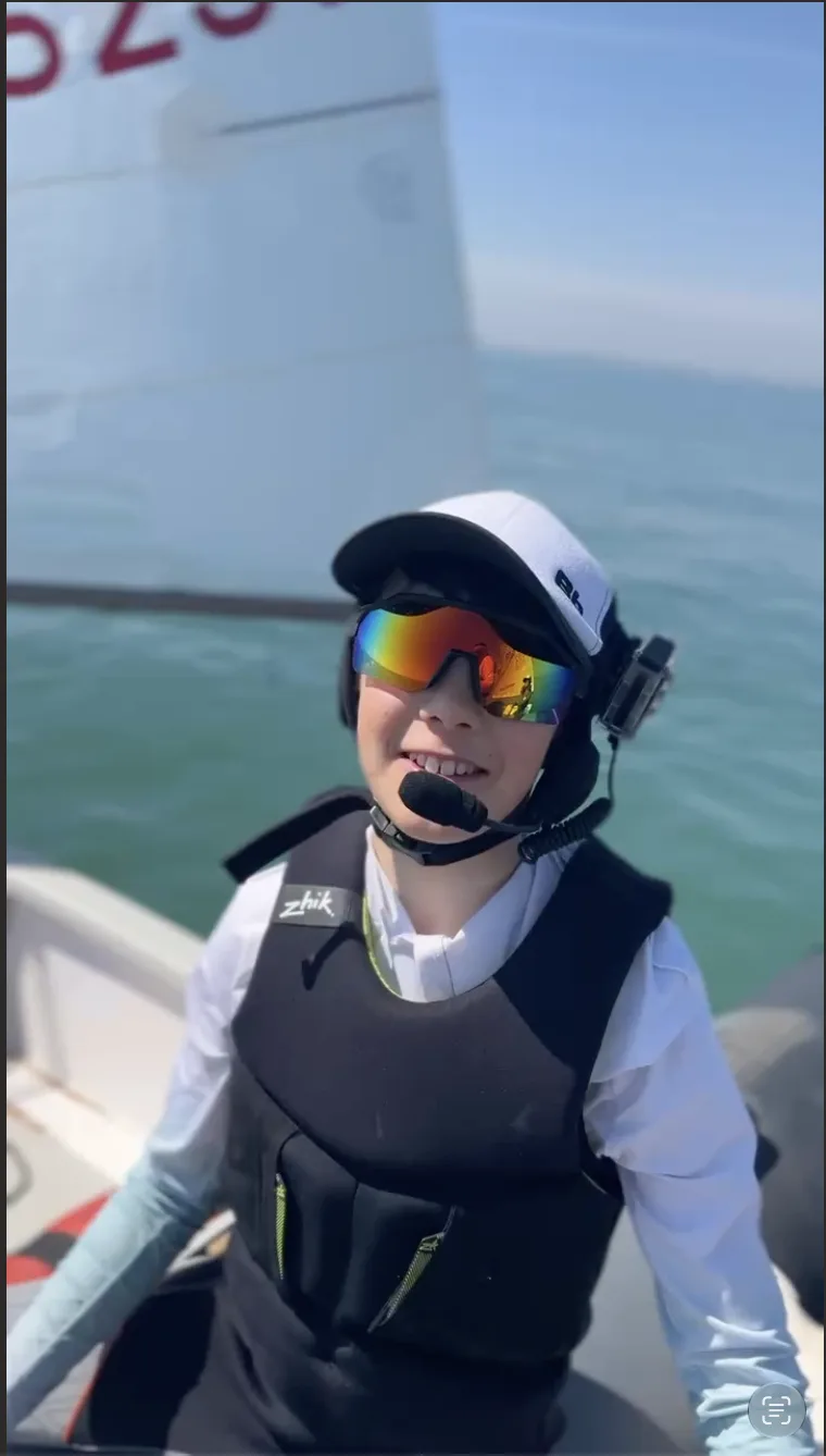 Finley on the water wearing a coaching headset